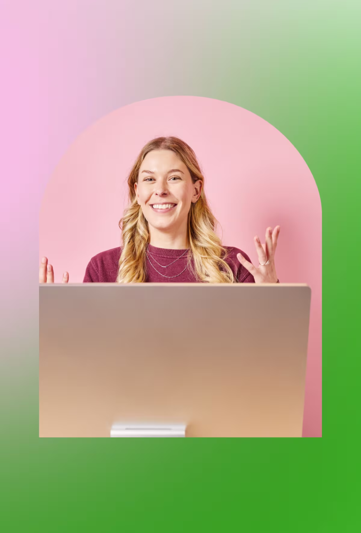 Image of a smiling woman at a desktop computer